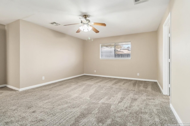 spare room with ceiling fan and carpet