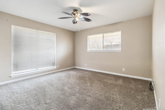 carpeted spare room featuring ceiling fan