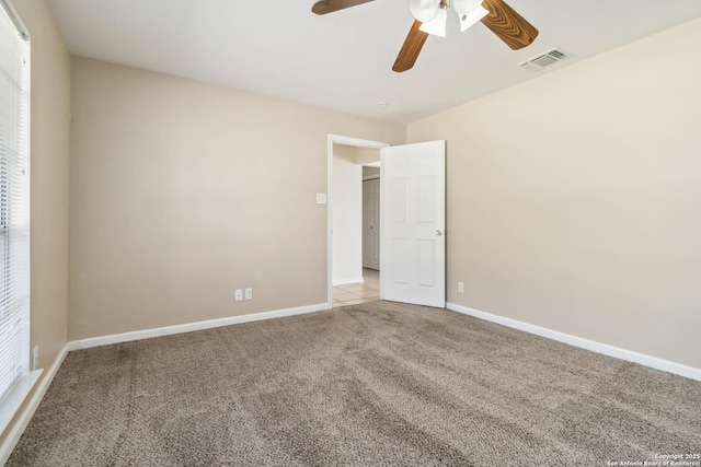 carpeted empty room featuring ceiling fan