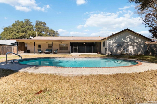 view of pool with ceiling fan, a yard, and a patio