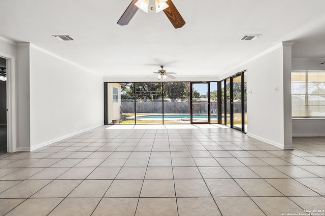 spare room with ornamental molding, light tile patterned flooring, and ceiling fan