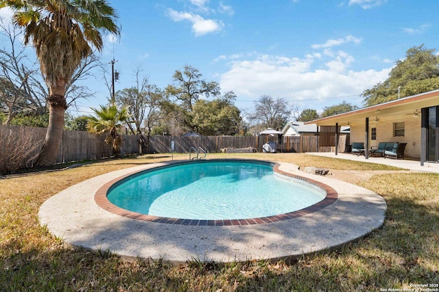 view of pool with a yard and a patio