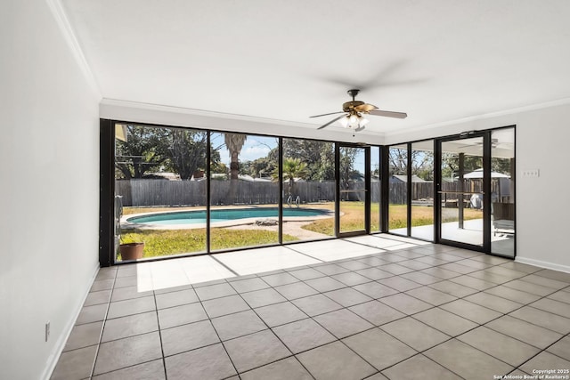 unfurnished sunroom with a healthy amount of sunlight and ceiling fan