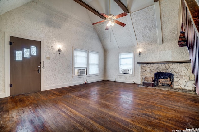 unfurnished living room featuring dark wood-type flooring, ceiling fan, cooling unit, high vaulted ceiling, and a stone fireplace