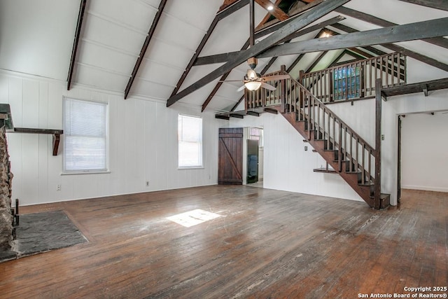 unfurnished living room with hardwood / wood-style flooring and lofted ceiling with beams