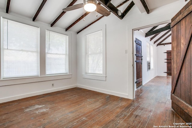 unfurnished room with lofted ceiling with beams, dark hardwood / wood-style floors, and ceiling fan