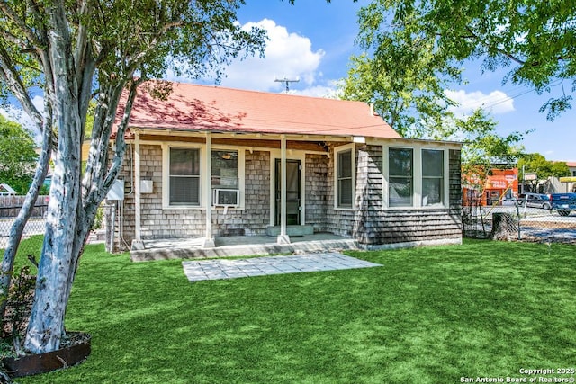 back of property with a patio and a lawn