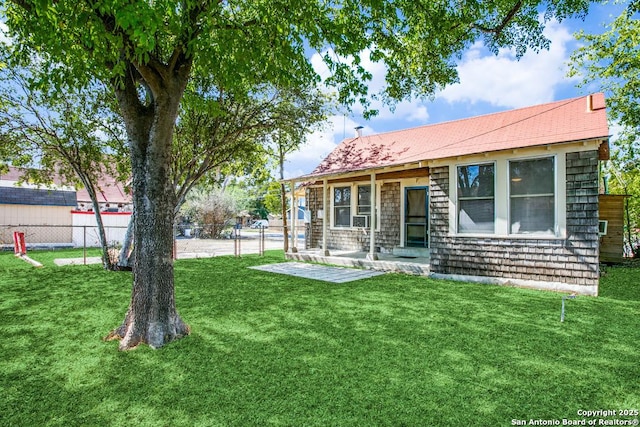 rear view of house with a lawn