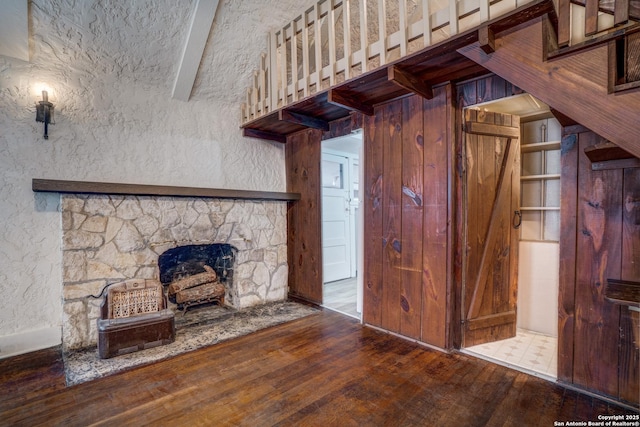 unfurnished living room featuring wood-type flooring and a fireplace