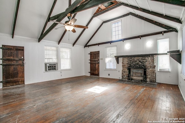 unfurnished living room with beam ceiling, a fireplace, dark hardwood / wood-style floors, and ceiling fan