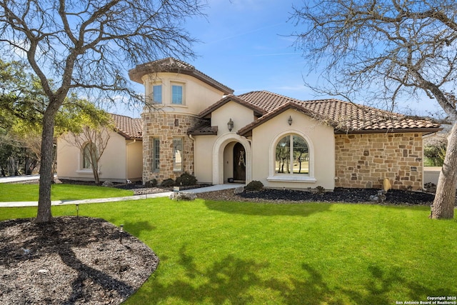 mediterranean / spanish home featuring a front lawn