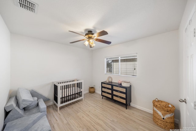 bedroom with ceiling fan and light hardwood / wood-style flooring