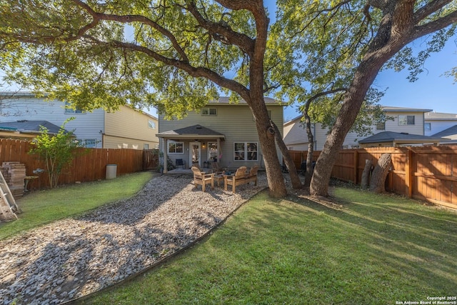 rear view of property featuring a yard and a patio area