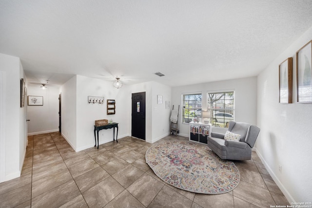 living room featuring tile patterned floors and a textured ceiling