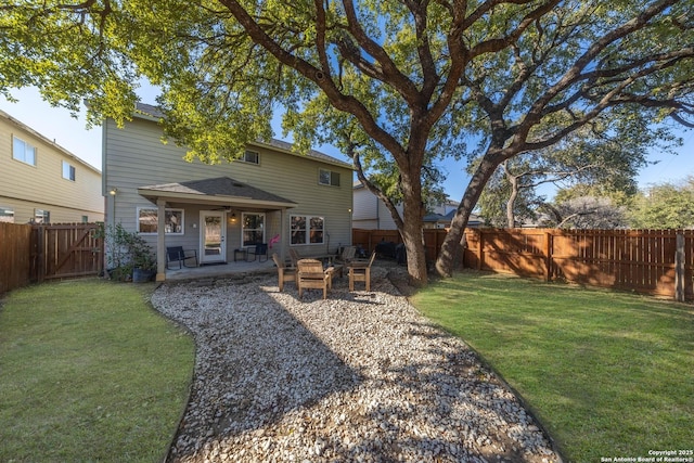 back of house with a patio and a yard