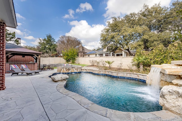 view of swimming pool featuring a gazebo, a patio area, pool water feature, and an in ground hot tub