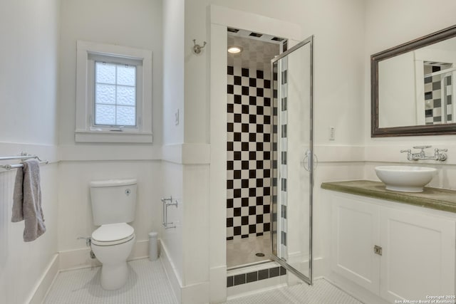 bathroom with an enclosed shower, vanity, tile patterned floors, and toilet