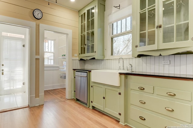 kitchen with light hardwood / wood-style floors, a healthy amount of sunlight, dishwasher, and sink