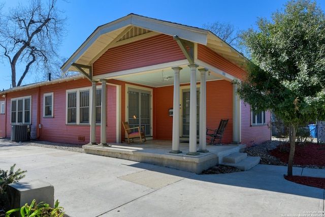 back of property with a patio, covered porch, and central air condition unit