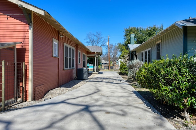 view of side of property with central air condition unit