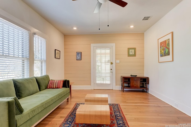 living room with ceiling fan and light wood-type flooring