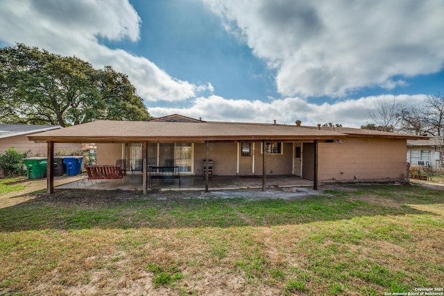 rear view of property with a patio and a yard