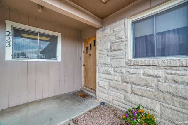 doorway to property featuring stone siding