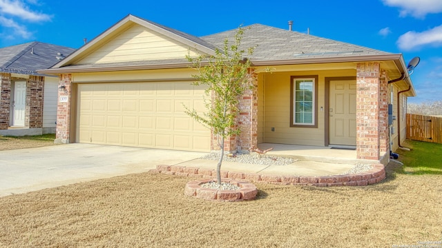 ranch-style house with a garage and a front yard