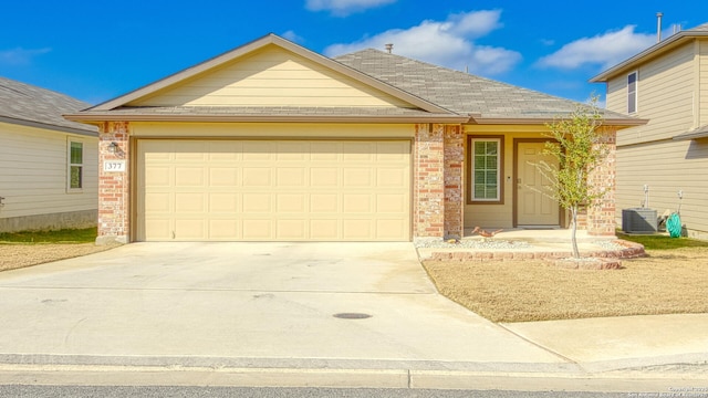 view of front of house featuring a garage and central air condition unit