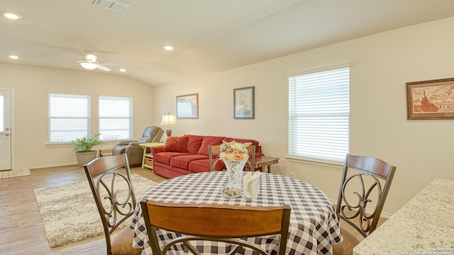 dining room with vaulted ceiling, ceiling fan, and light wood-type flooring