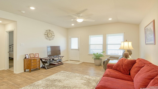 living room featuring vaulted ceiling, ceiling fan, and light hardwood / wood-style floors