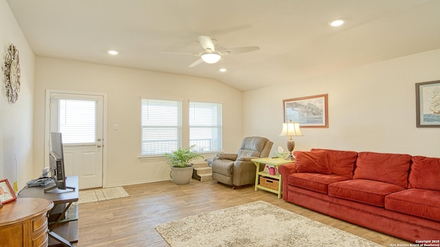 living room featuring lofted ceiling, ceiling fan, and light wood-type flooring