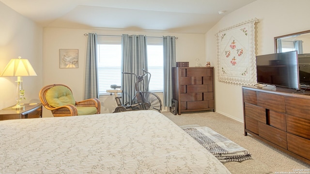 carpeted bedroom with vaulted ceiling