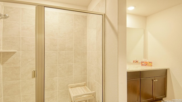 bathroom featuring vanity and a shower with shower door