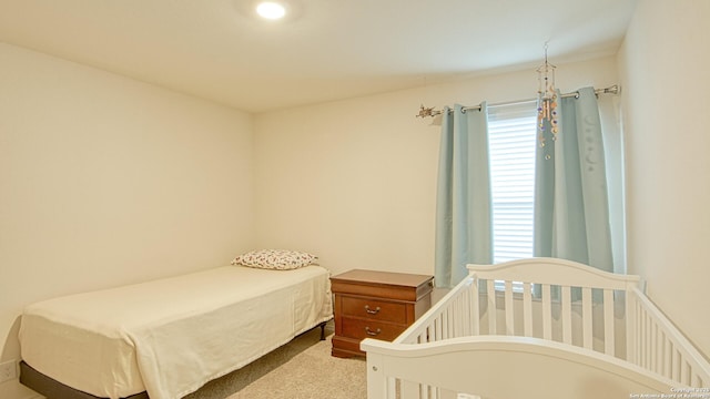 bedroom with light colored carpet