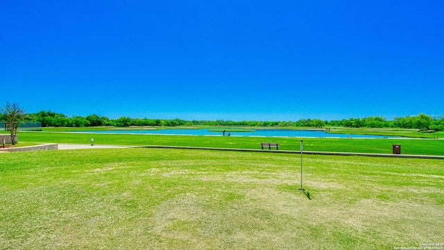 view of home's community with a yard and a water view