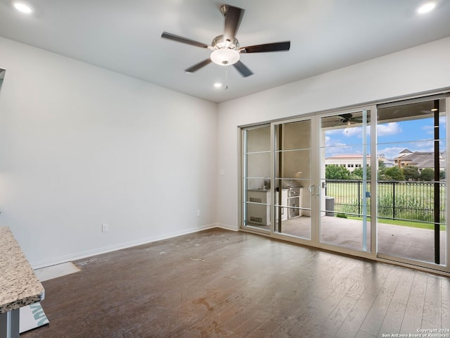 unfurnished room featuring ceiling fan and dark hardwood / wood-style floors