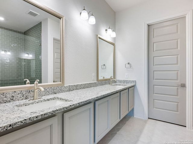 bathroom featuring vanity and tiled shower