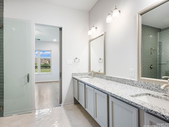 bathroom featuring walk in shower and vanity