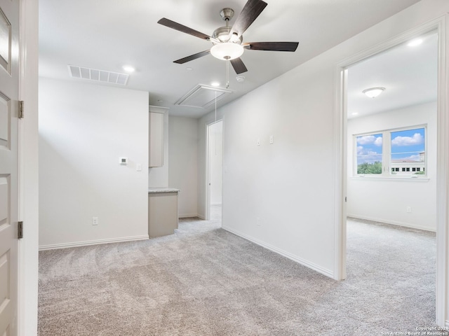 unfurnished room featuring light colored carpet and ceiling fan