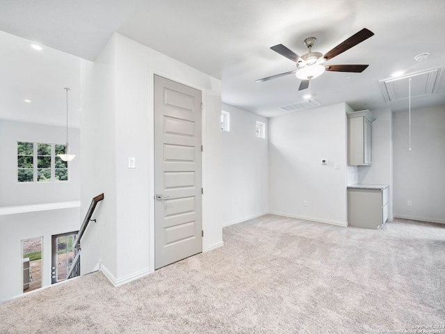 interior space featuring ceiling fan and light carpet