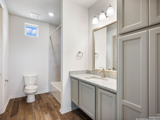 full bathroom with vanity, shower / tub combination, and toilet