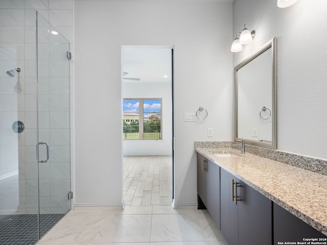 bathroom with vanity and a shower with shower door