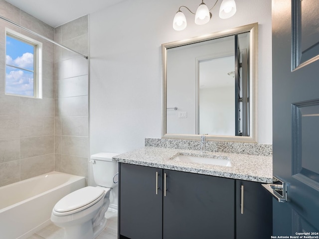 full bathroom featuring tiled shower / bath, vanity, and toilet