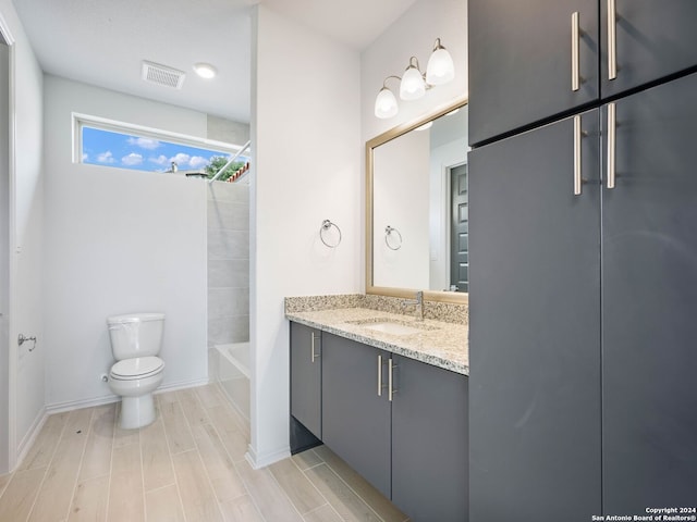 full bathroom with vanity, tub / shower combination, and toilet