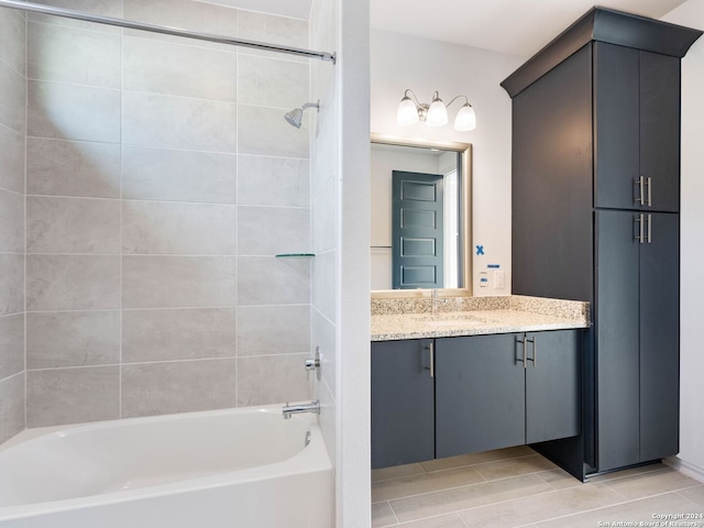 bathroom featuring tiled shower / bath and vanity