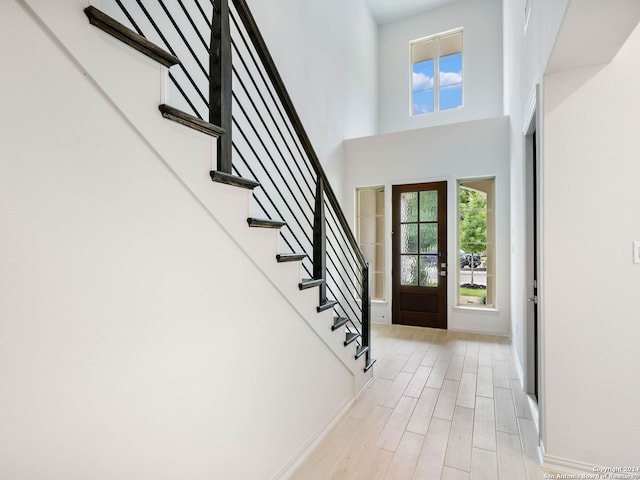 entryway with a high ceiling and a wealth of natural light