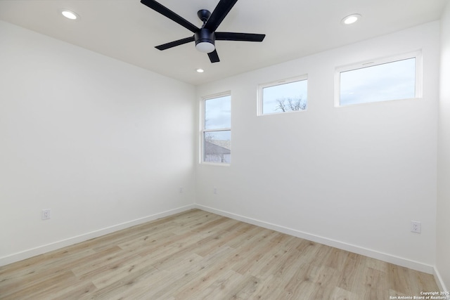 spare room featuring light hardwood / wood-style flooring and ceiling fan