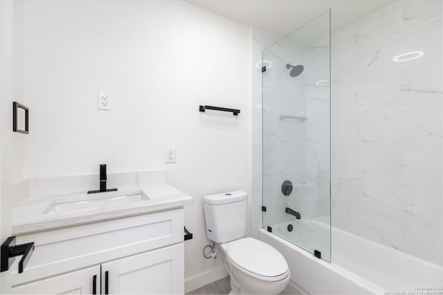 full bathroom with tiled shower / bath, vanity, and toilet