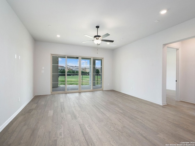 spare room featuring ceiling fan and light hardwood / wood-style floors